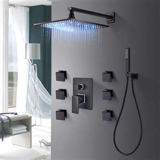 Walk-in shower with matte black shower hardware creating contrast against light wall tile